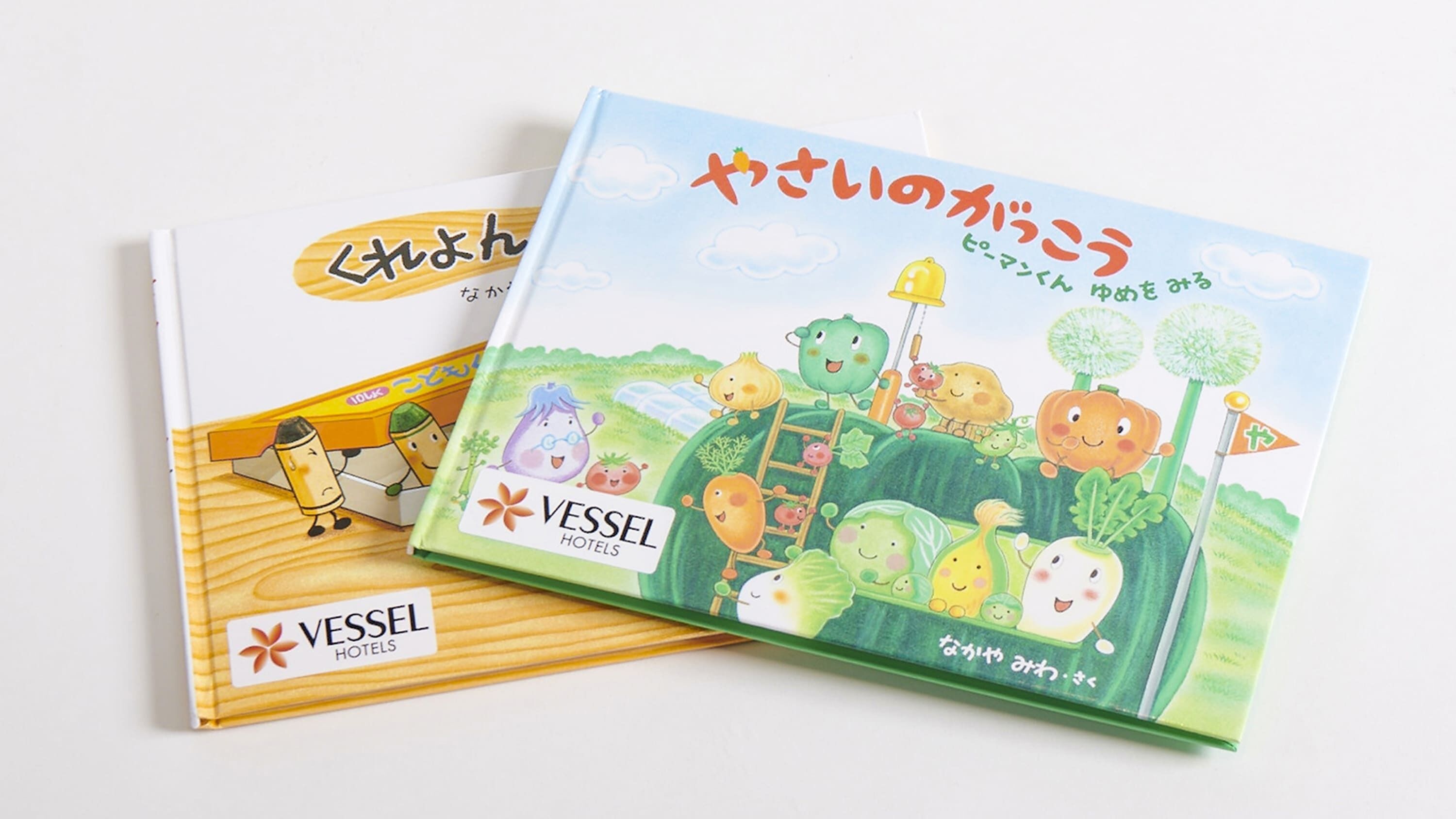 Two books with illustrations of vegetables and the text "VESSEL HOTELS" on the cover.