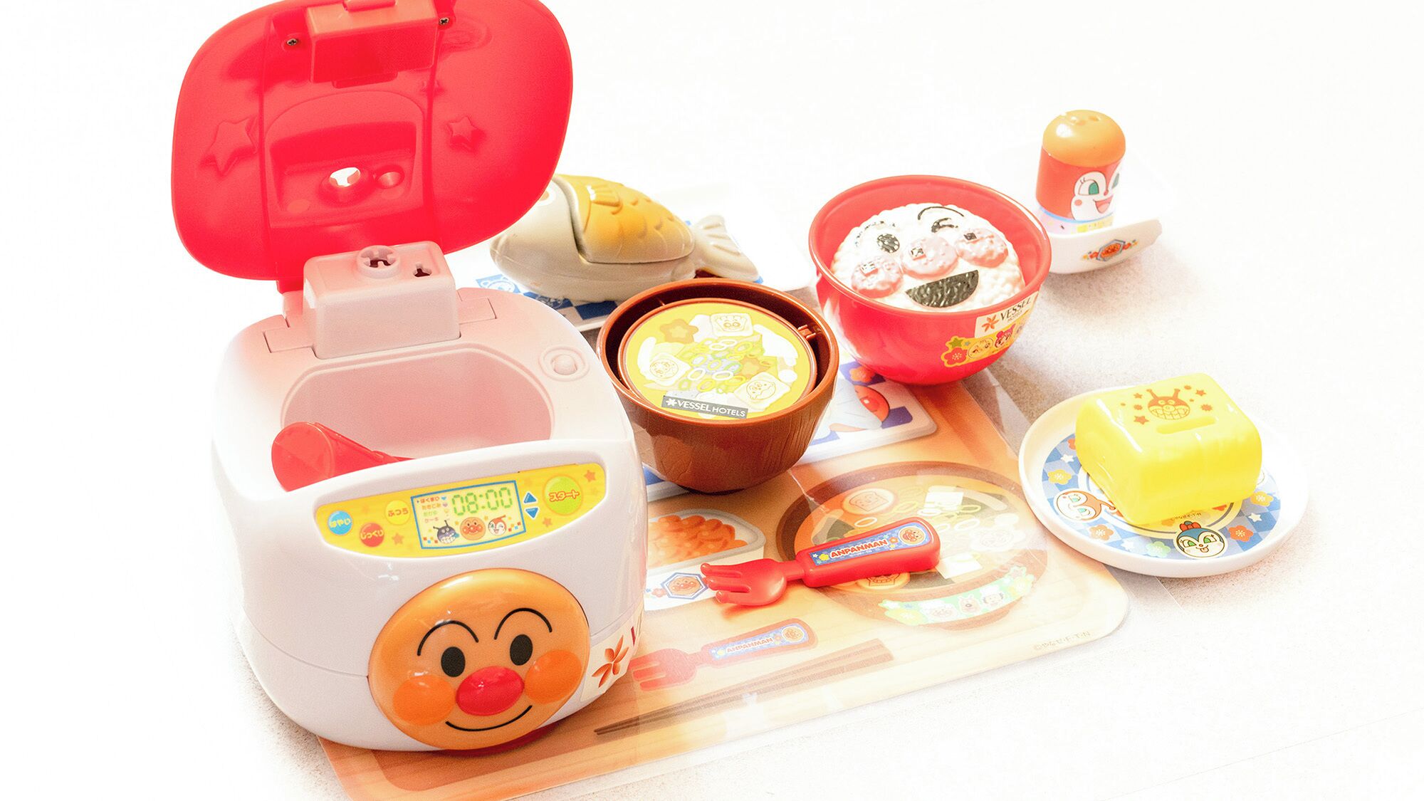 A children's meal set with a rice cooker, bowls, and a butter dish.