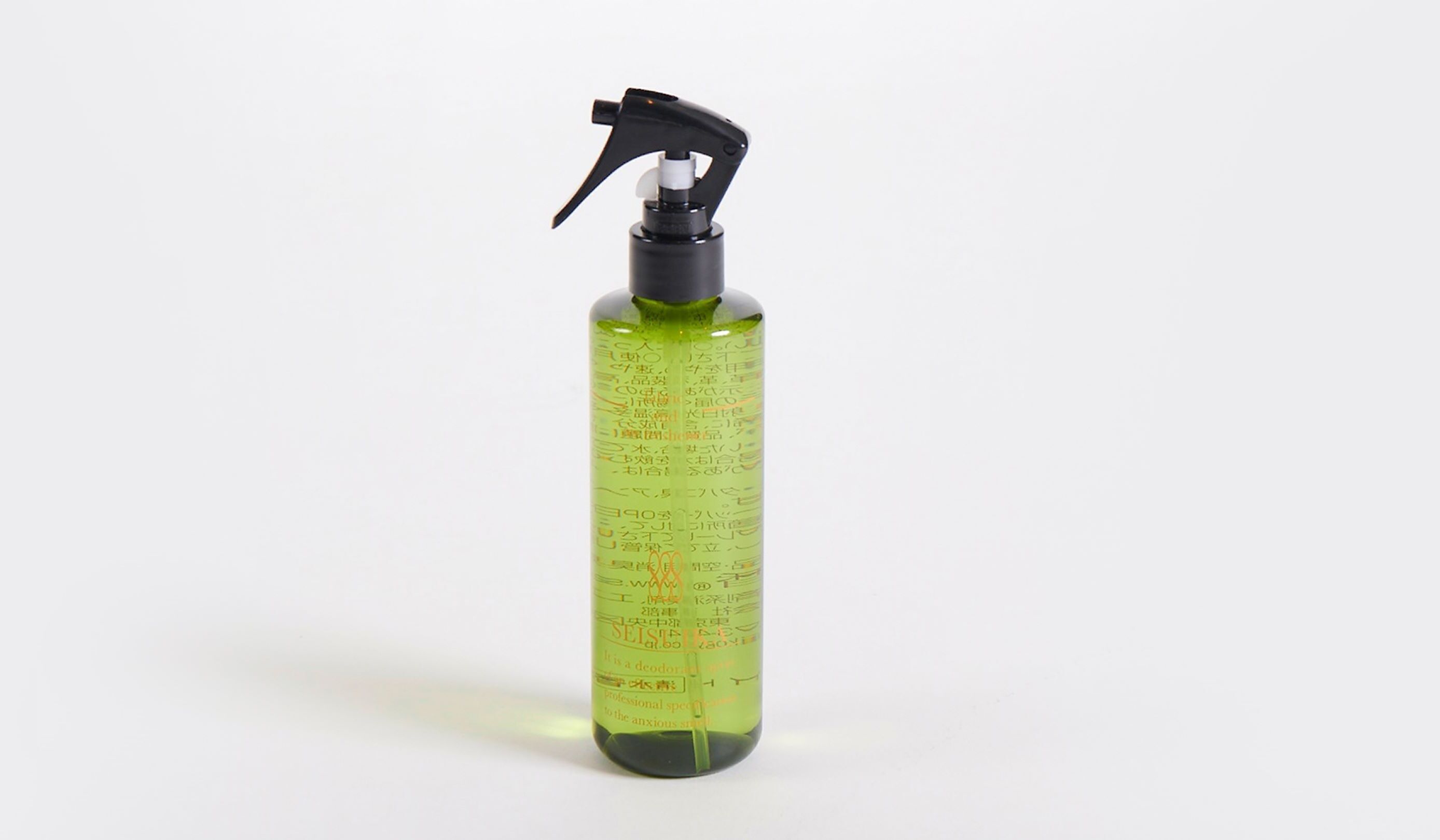 A green spray bottle with measurement markings and text.