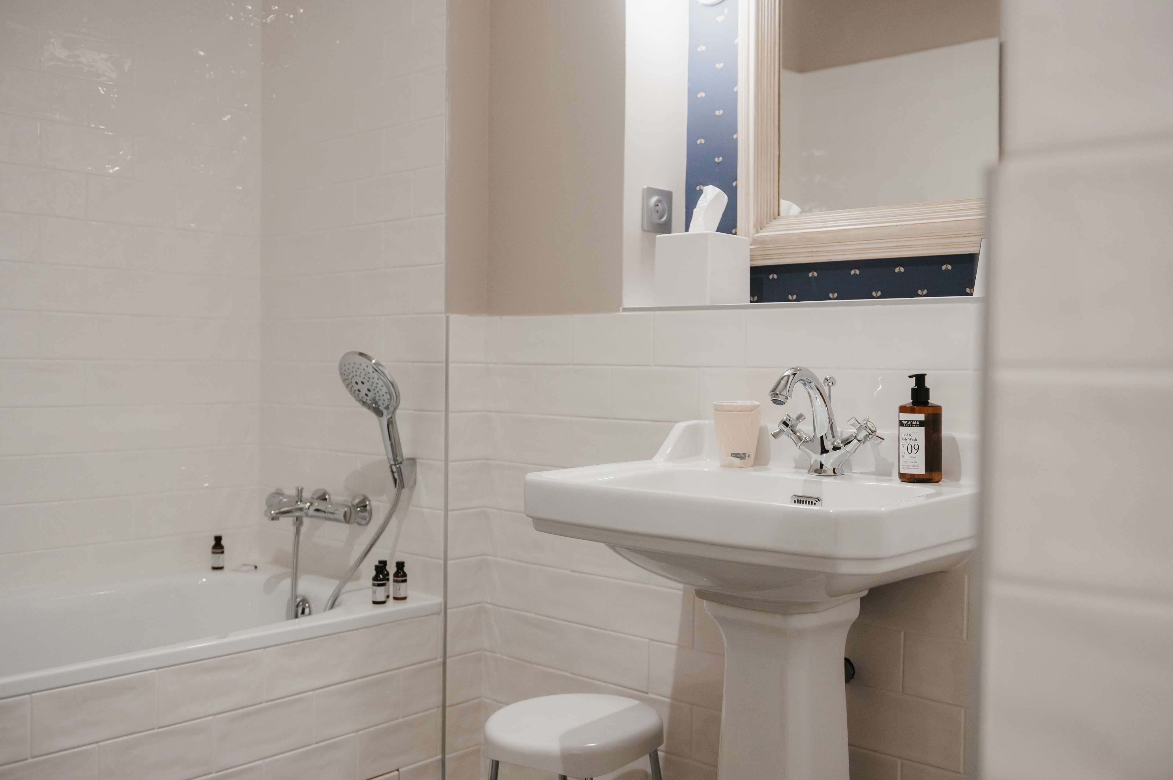 A bathroom with a bathtub, a sink, and a toilet.