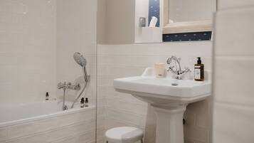 A bathroom with a bathtub, a sink, and a toilet.