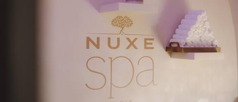 A spa sign with the name 'NUXE SPA PARIS' and a stylized tree logo.