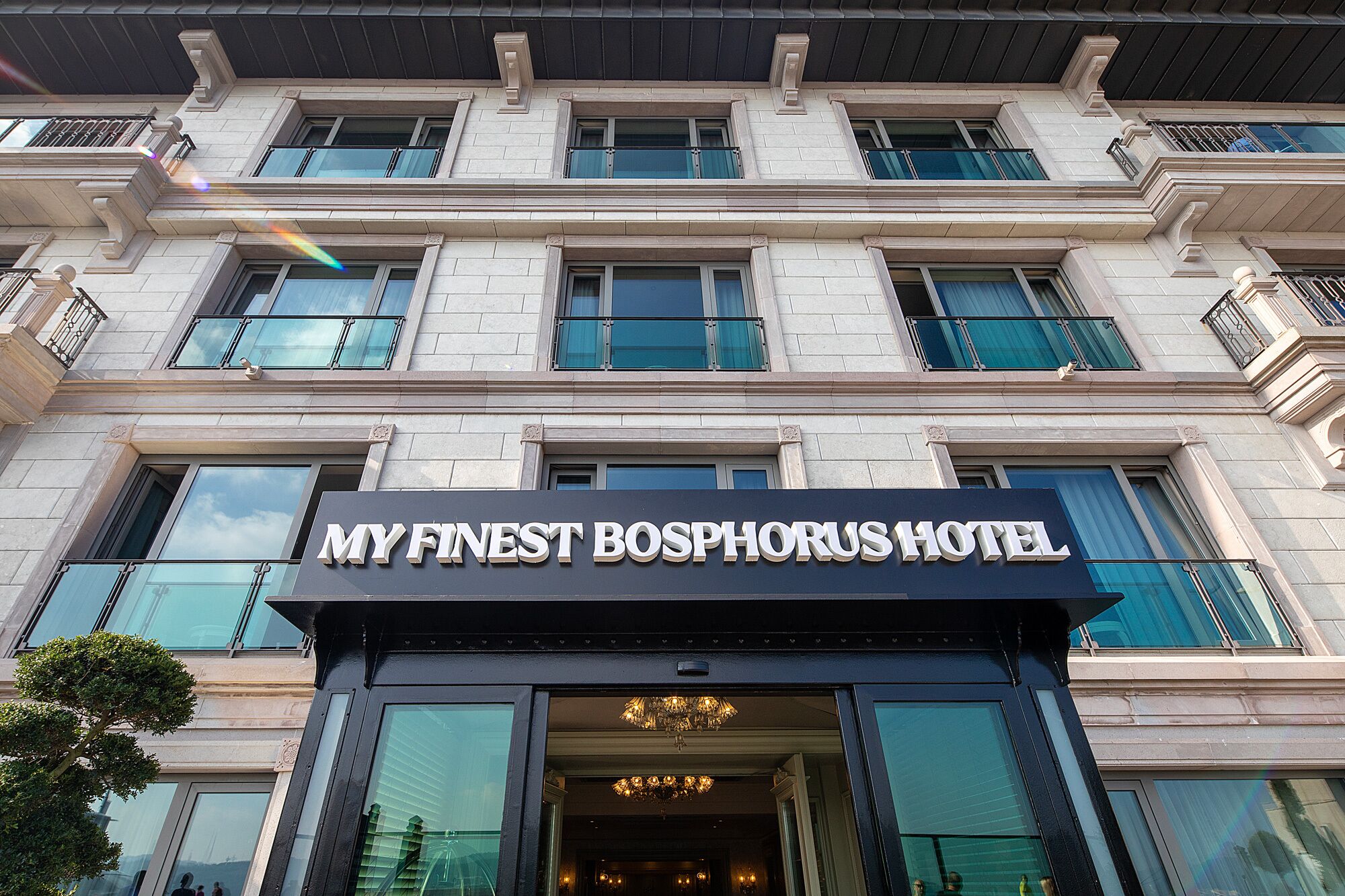 A hotel entrance with a sign reading "MY FINEST BOSPHORUS HOTEL."
