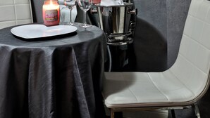 A dining area with a table set for two, a candle, and a wine glass. - Albergo Al Castello (Pomezia)
