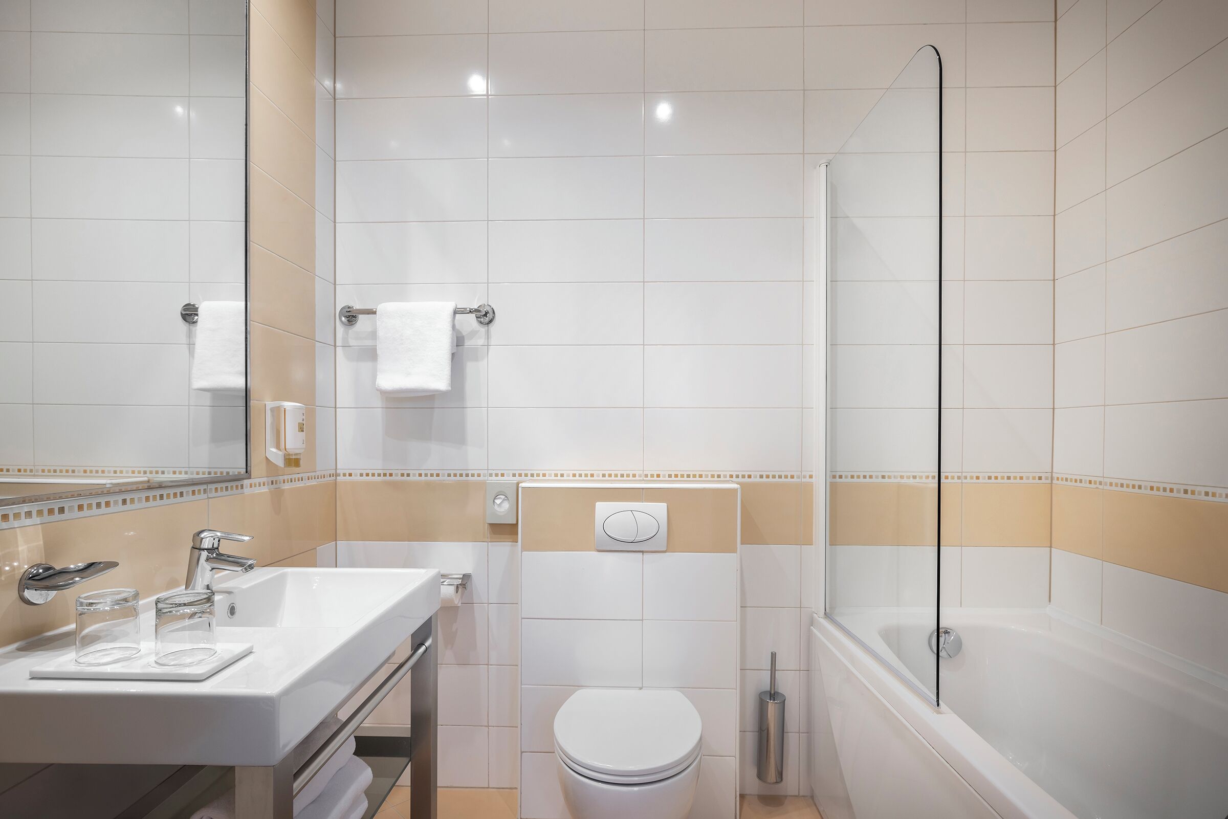 A modern bathroom with a sink, toilet, and shower.