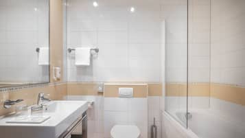 A modern bathroom with a sink, toilet, and shower.