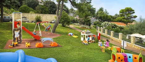 A playground with slides, swings, and climbing structures.