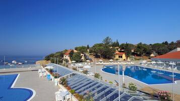 Indoor pool, outdoor pool, pool umbrellas, pool loungers