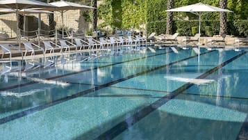 Una piscina al aire libre de temporada, sombrillas