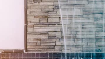 A stone wall with a water feature.