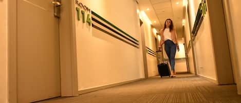 A hotel corridor with a sign indicating room number 14.