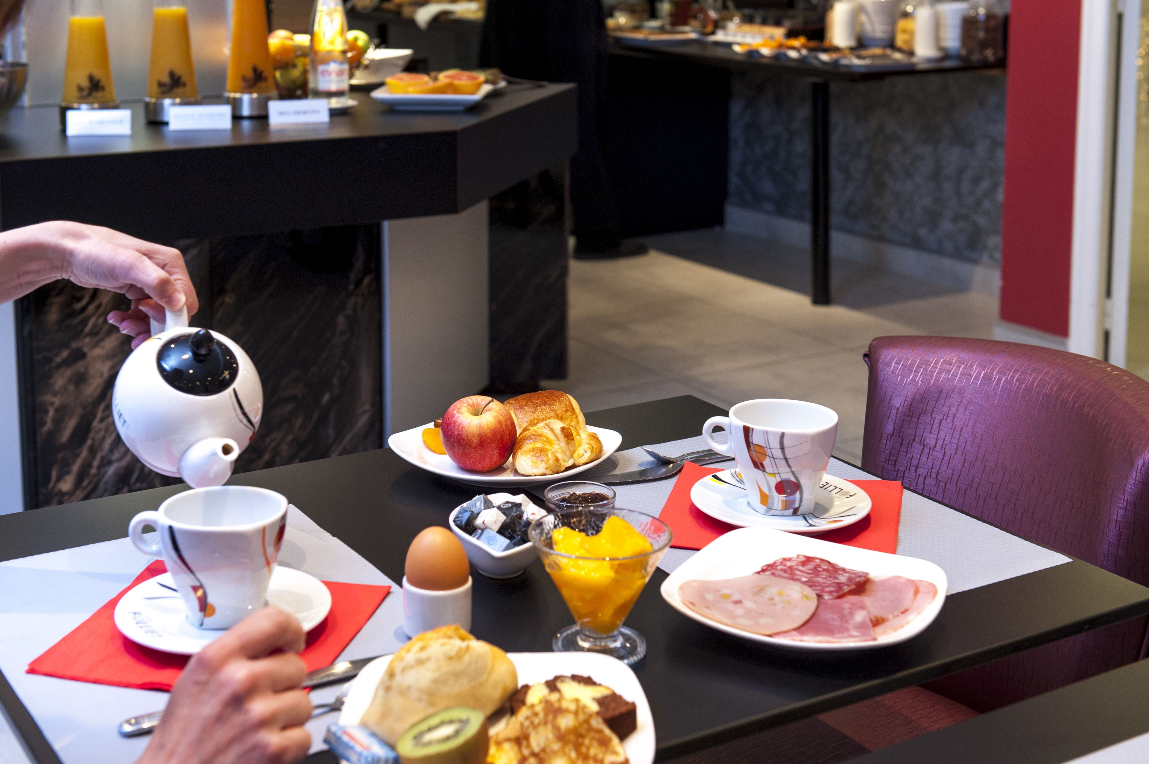 A breakfast buffet with various food items and a coffee machine.