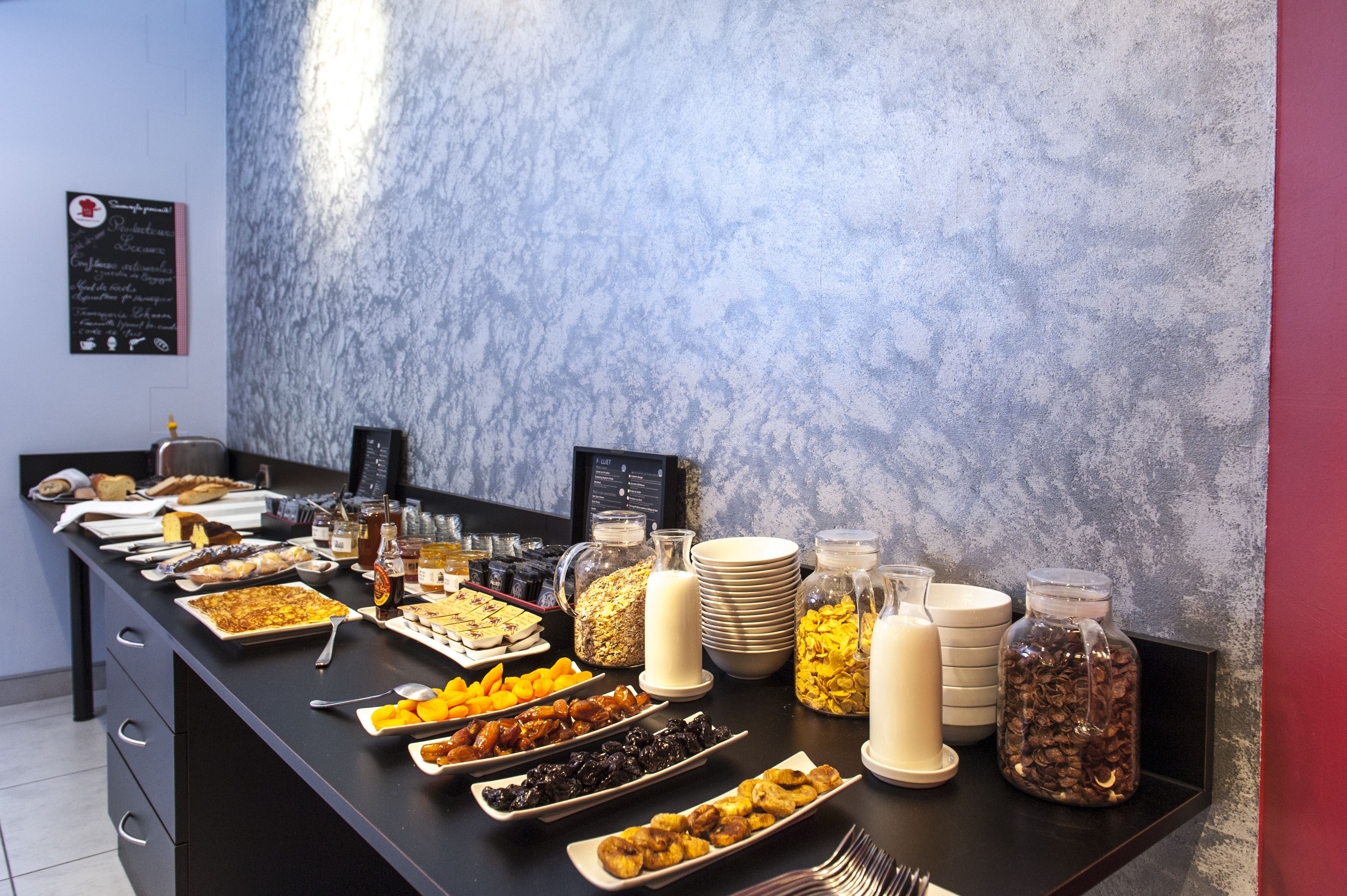 A buffet with various food items and beverages.