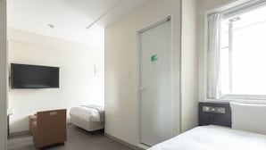 A hotel room with a bed, a desk, a chair, a television, a door, and a window. - Vessel Inn Hiroshima Station (Hiroshima)