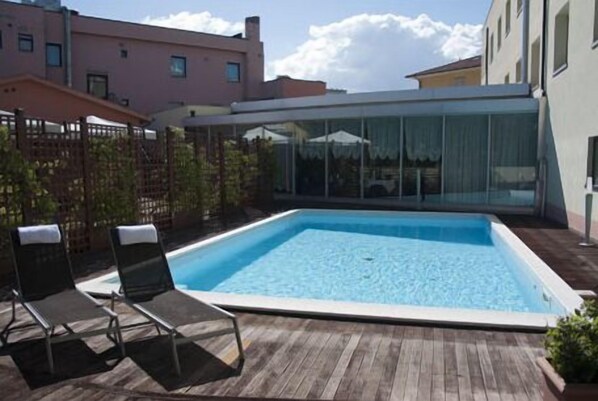 Seasonal outdoor pool, open 8:30 AM to 7:00 PM, pool umbrellas