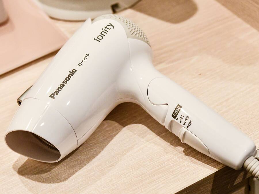A Panasonic ionity hair dryer on a wooden surface.