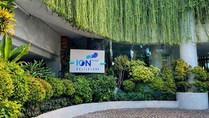 A hotel entrance with a sign reading "ION hotel Bali-Benora," surrounded by lush greenery and a paved walkway. - Ion Bali Benoa (Nusa Dua)