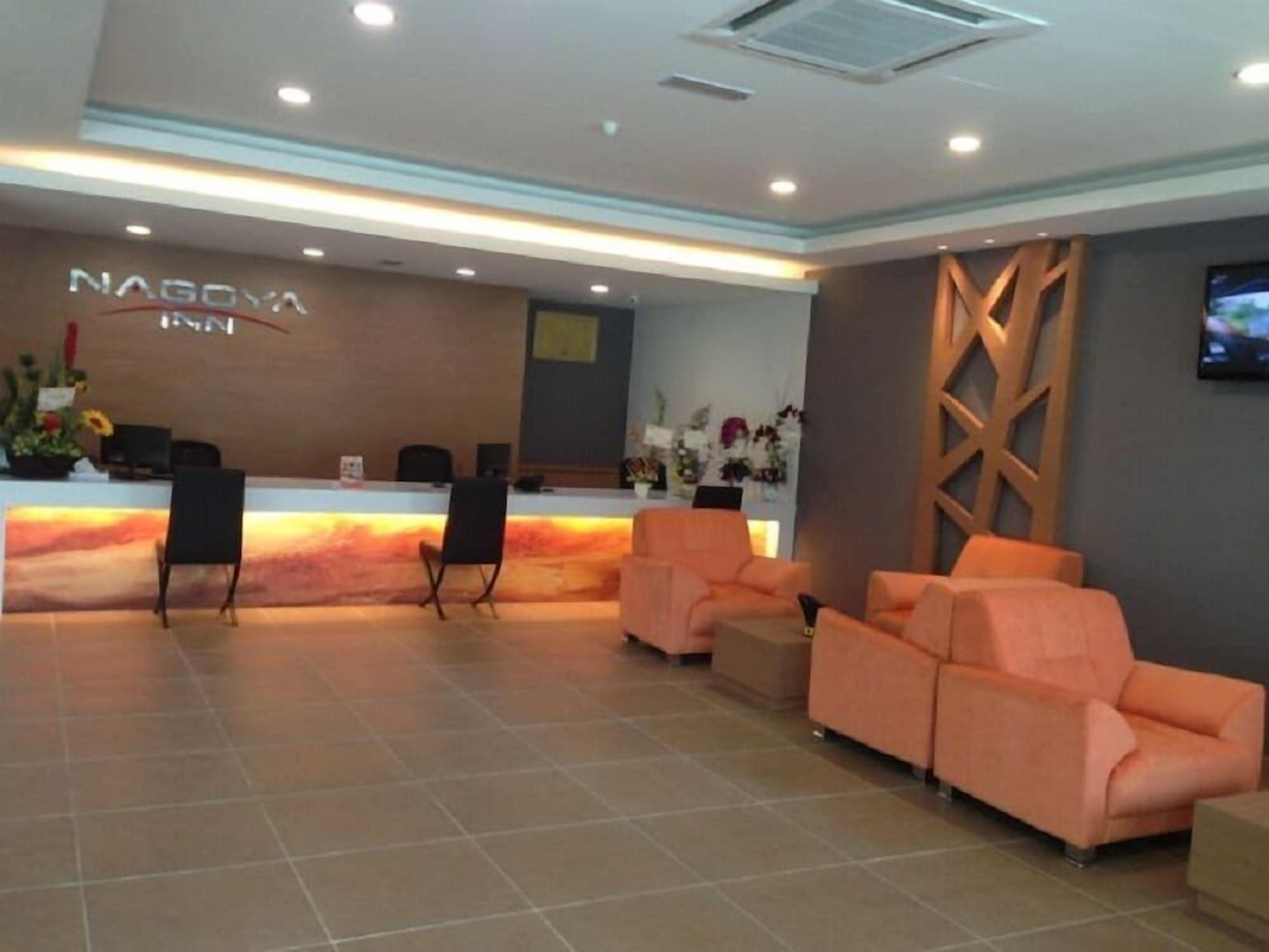 A reception area with a counter, several chairs, and sofas.