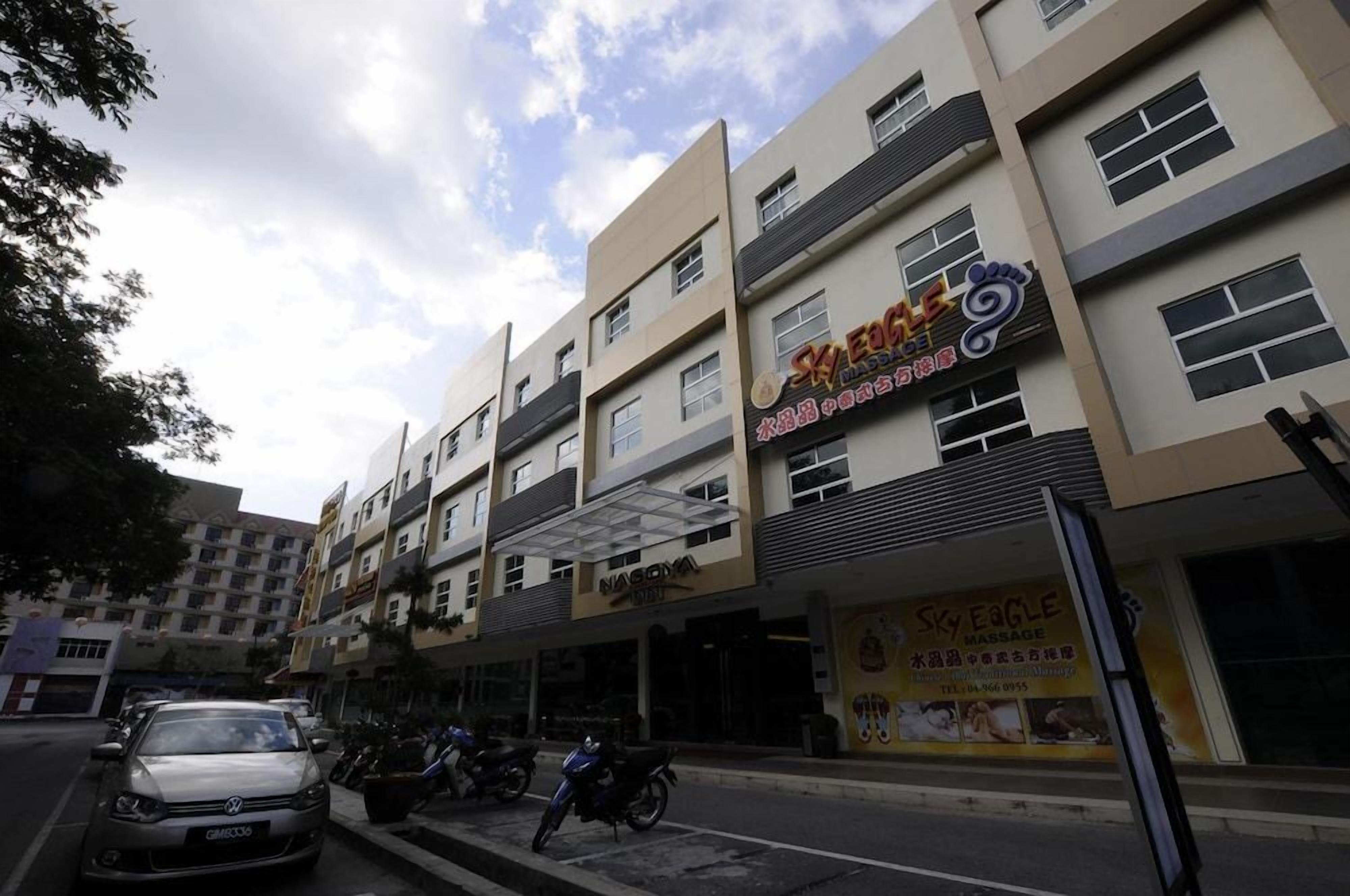 A multi-story building with commercial establishments on the ground floor, including a massage parlor.
