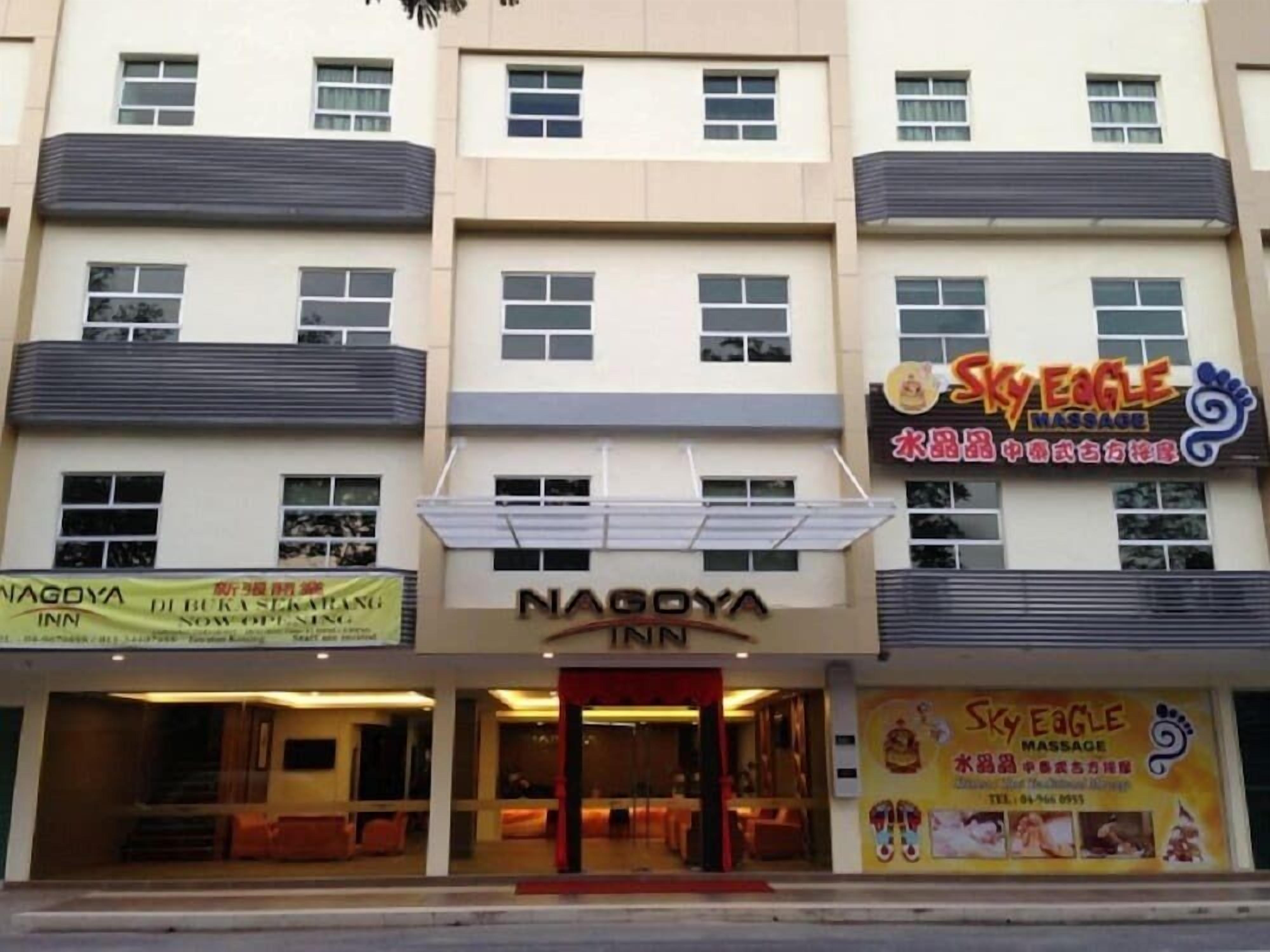 A building with a sign for Nagoya Inn and Sky Eagle Massage.