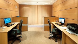 A modern office space with two desks, each equipped with a computer, keyboard, and chair. - Hotel Prestige (Makkah)
