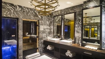 Features a luxurious bathroom with a large mirror, two sinks, and a heated floor.