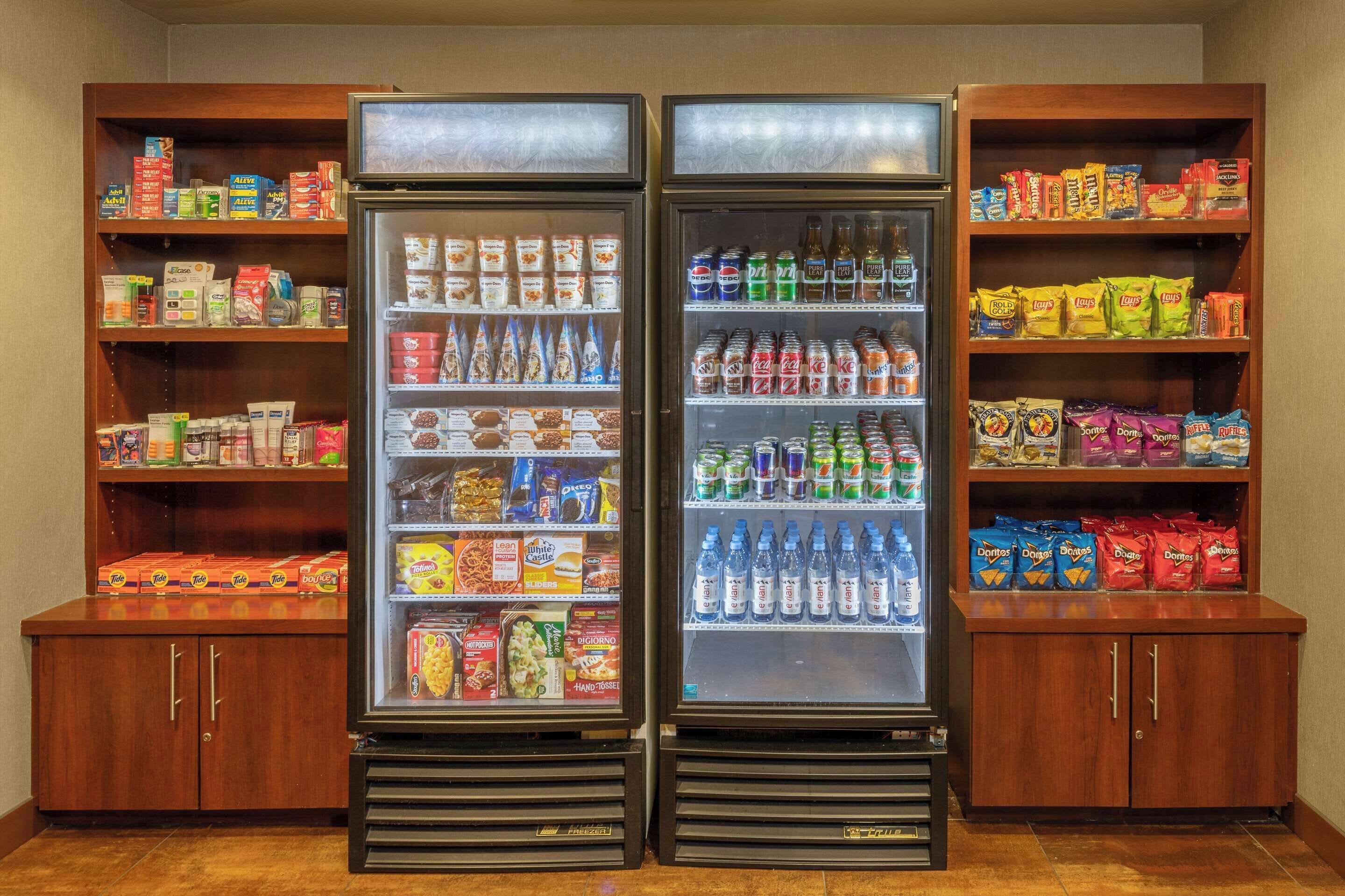A vending machine area with snacks, drinks, and packaged goods.