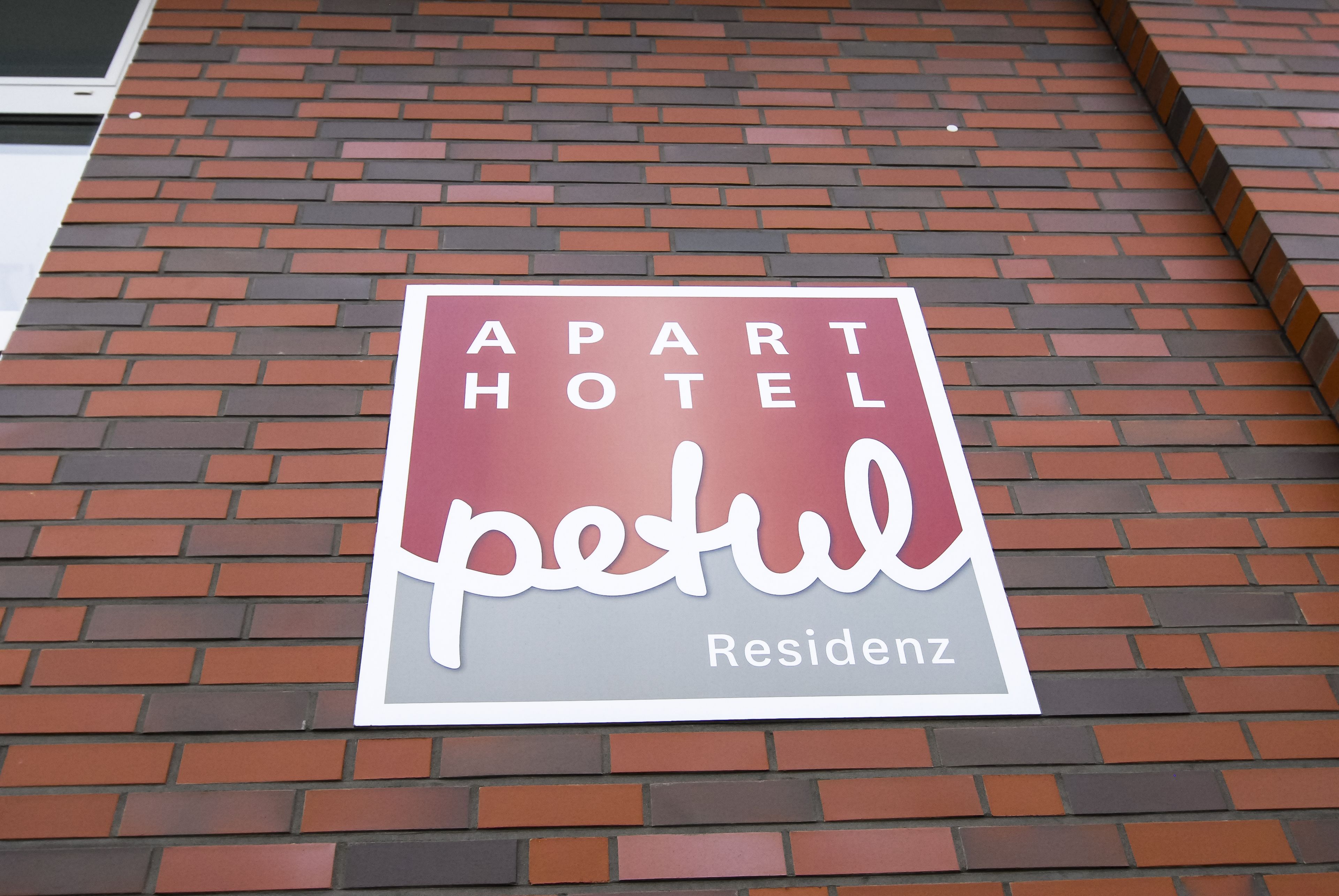 A sign for an apartment hotel named "Petul Residency."