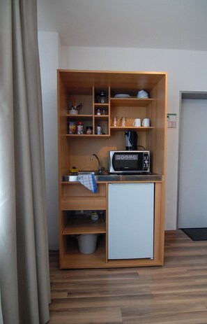 Fridge, microwave, coffee/tea maker, cookware/dishes/utensils