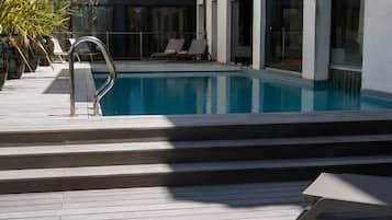 Seasonal outdoor pool, open 9:00 AM to 9:00 PM, pool umbrellas