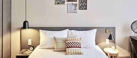 Hypo-allergenic bedding, desk, laptop workspace, blackout drapes