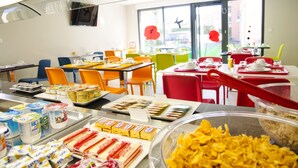 A buffet area with various food items and seating arrangements.