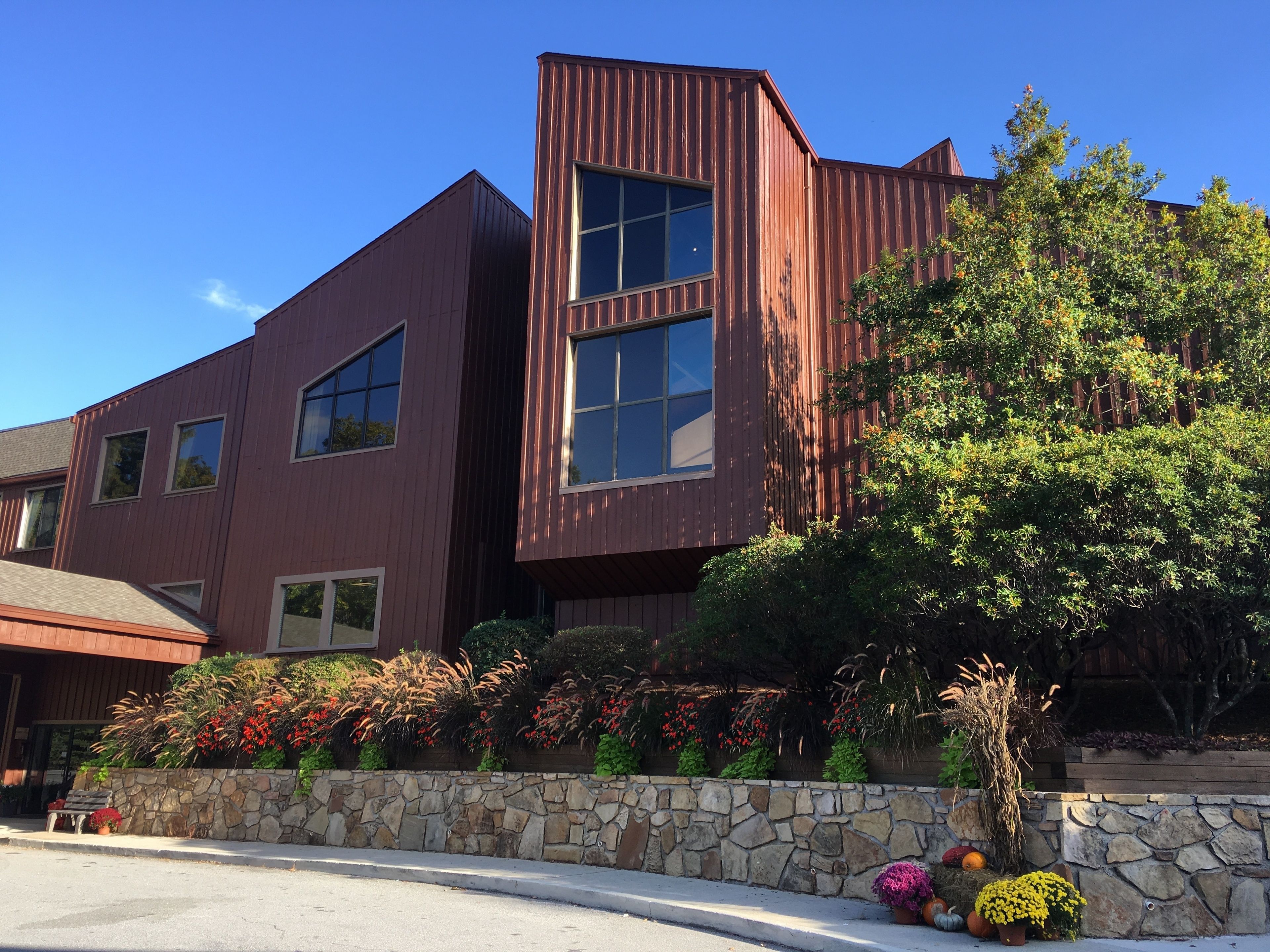 A modern building with a stone facade and large windows.