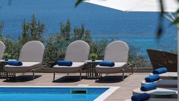 Outdoor pool, open 8:00 AM to 7:00 PM, pool umbrellas, pool loungers