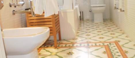 A bathroom with a toilet, sink, and shower.