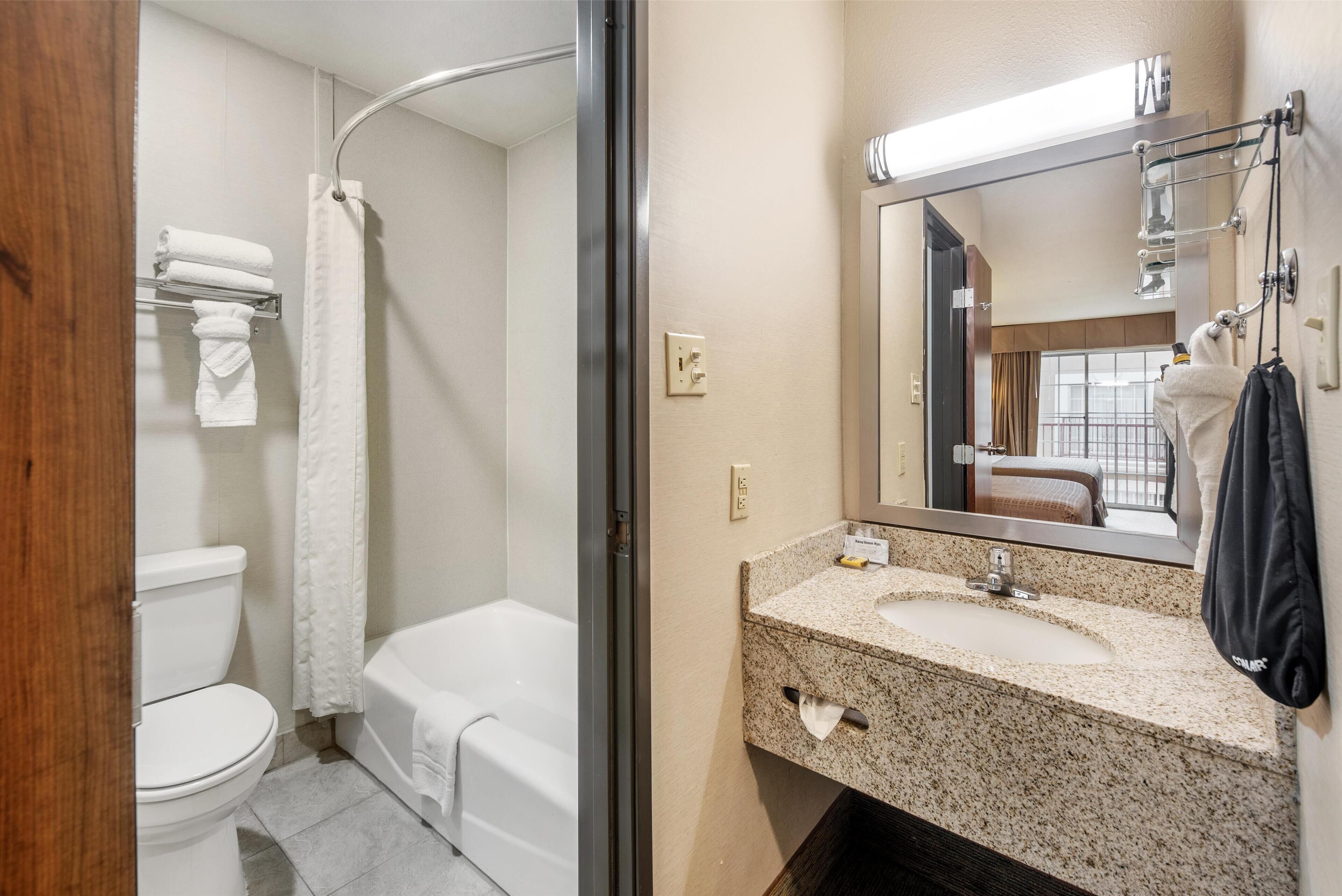 standard room, 2 queen beds, refrigerator & microwave, pool view | bathroom | combined shower/bathtub, free toiletries, hair dryer, towels