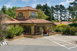 A two-story house with a tiled roof, large windows, and a paved driveway. - Sonoma Coast Villa (Bodega)