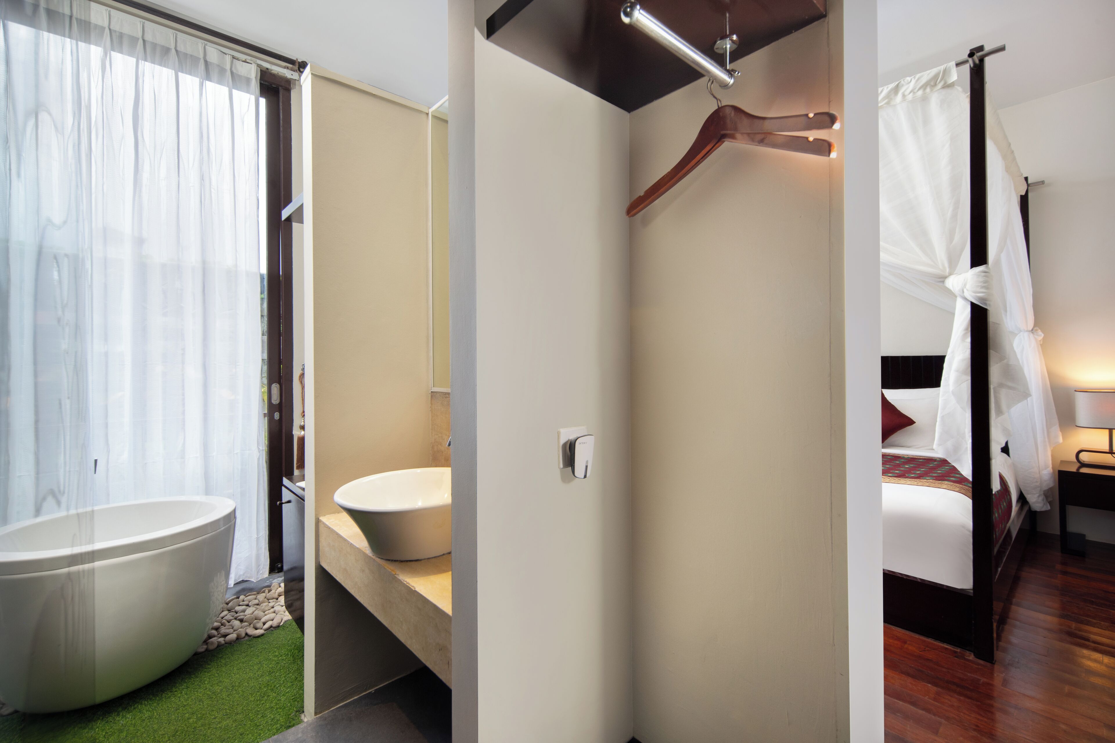A modern bathroom with a freestanding bathtub, a sink, and a shower area.