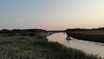 A river with boats and a bridge in the background.