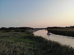 A river with boats and a bridge in the background.