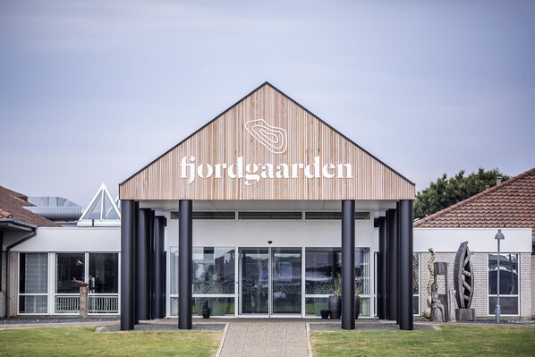 A modern building with a wooden facade and the name 'jordgaarden' prominently displayed.