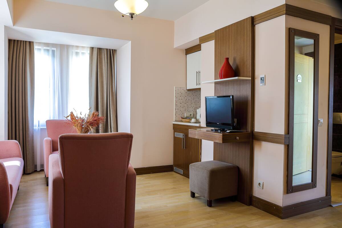 Junior Room, 1 Bedroom, Mountain View | Living area | 32-inch TV with satellite channels