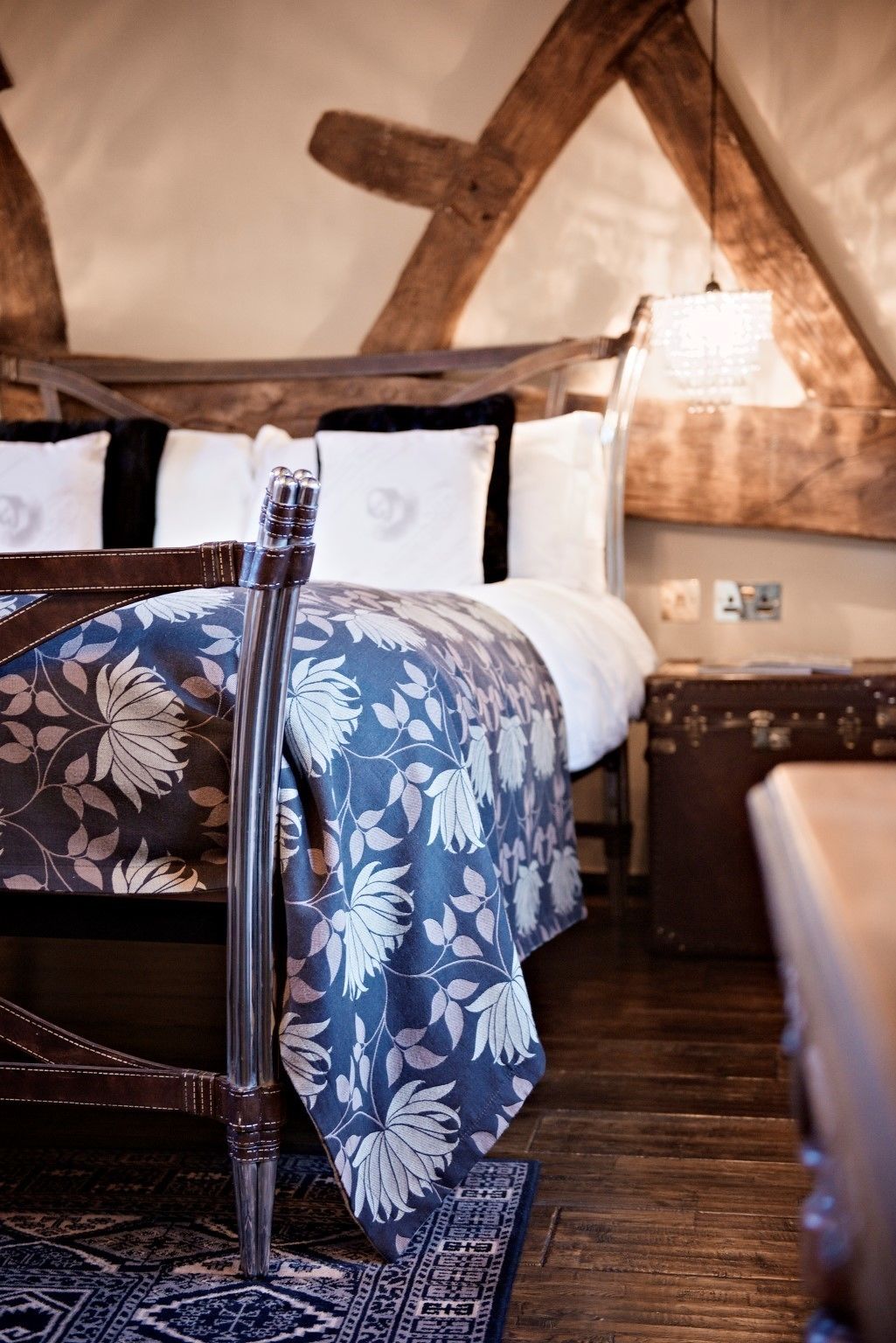 A tent-style bedroom with a bed, a guitar, and a patterned rug.