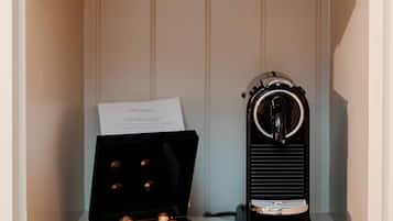 A shelf with a coffee maker, cups, and a menu.