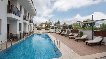 Seasonal outdoor pool, pool umbrellas, sun loungers