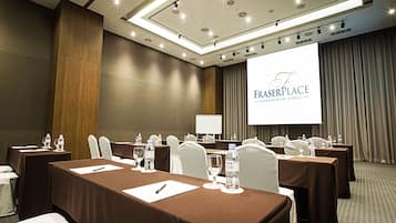 A conference room with tables, chairs, and a projector screen displaying "FASERPLACE NAMDAEUM-SEOUL".