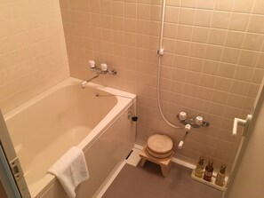 A bathroom with a bathtub, a shower, and a toilet.