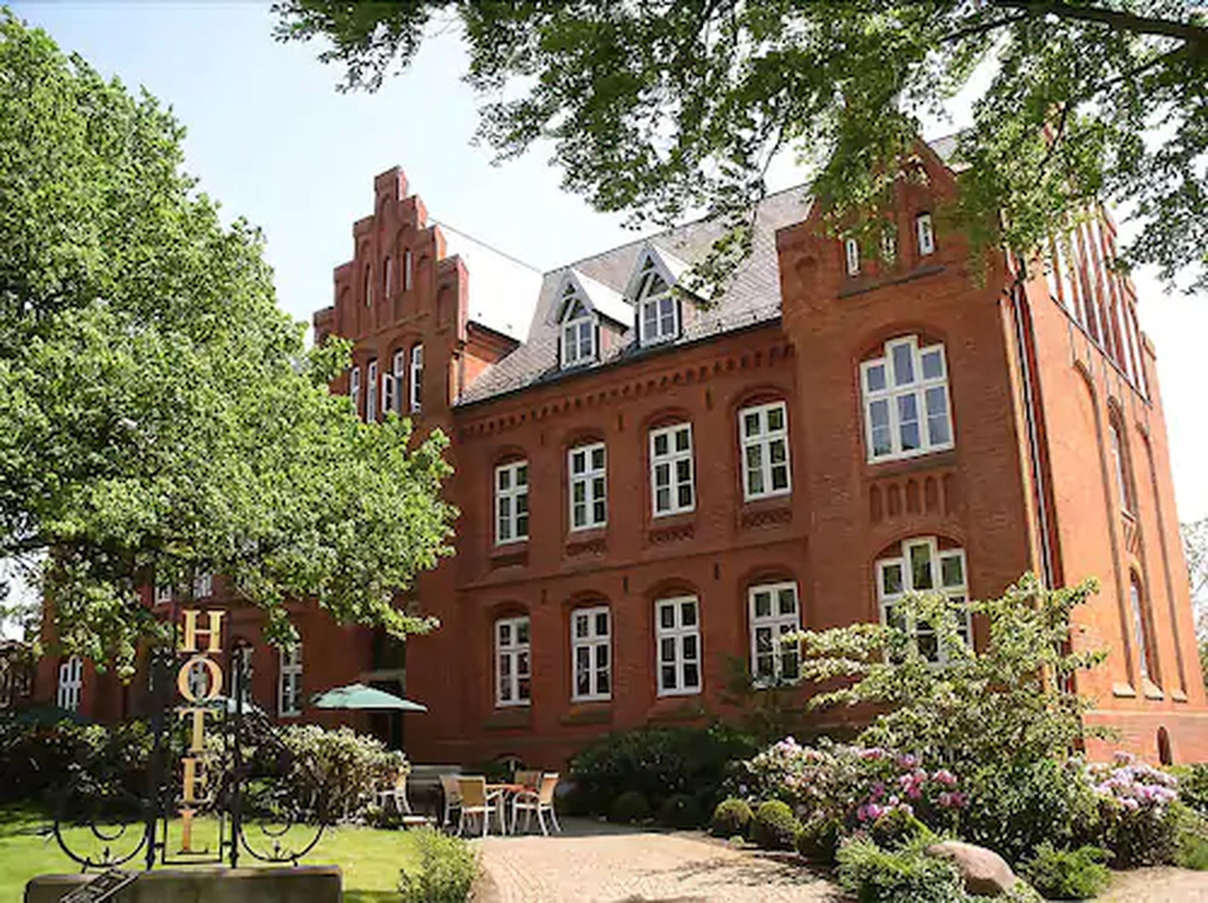 A large red brick building with multiple windows and a prominent entrance.