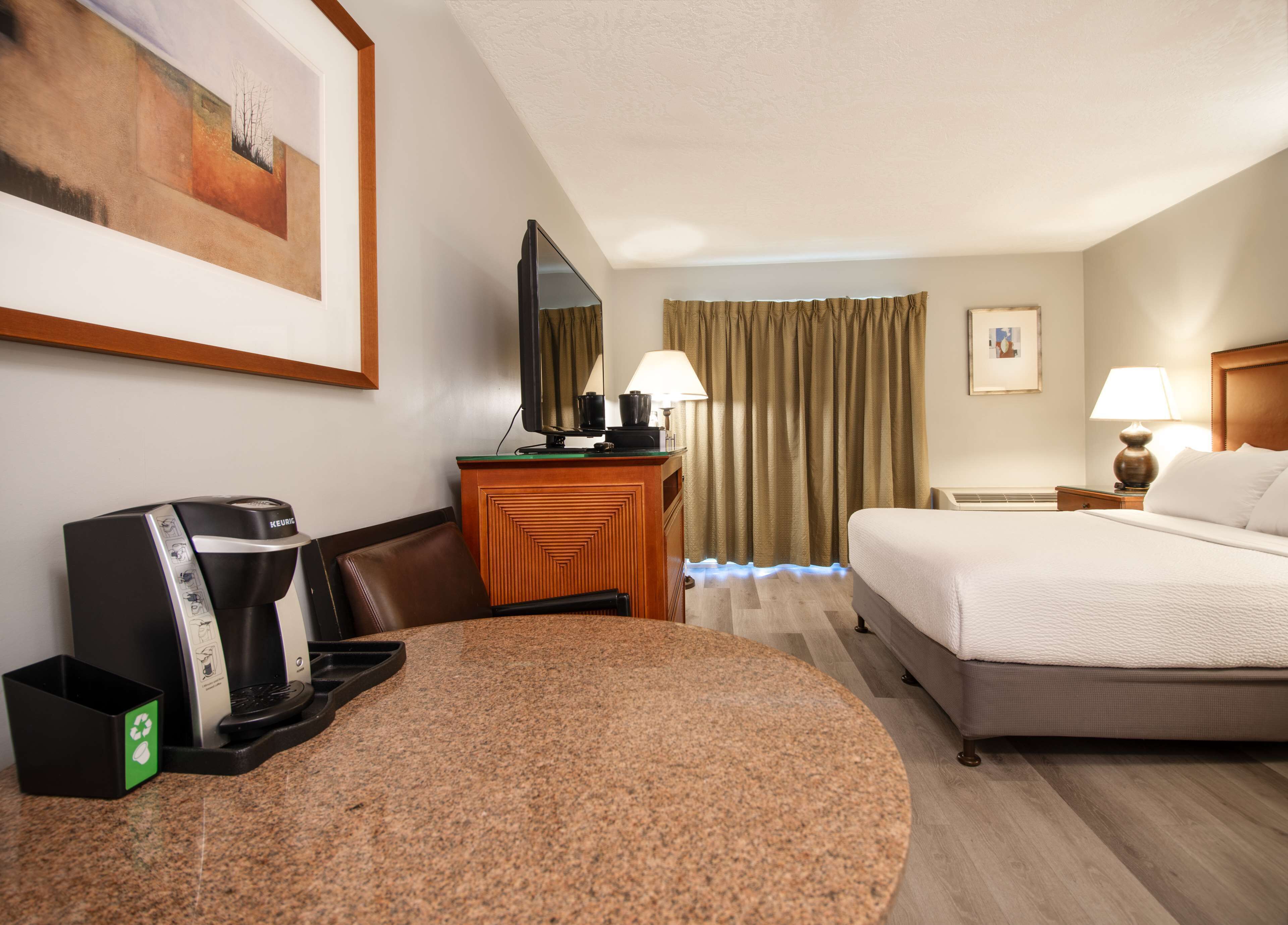 Premium bedding, desk, laptop workspace, blackout drapes