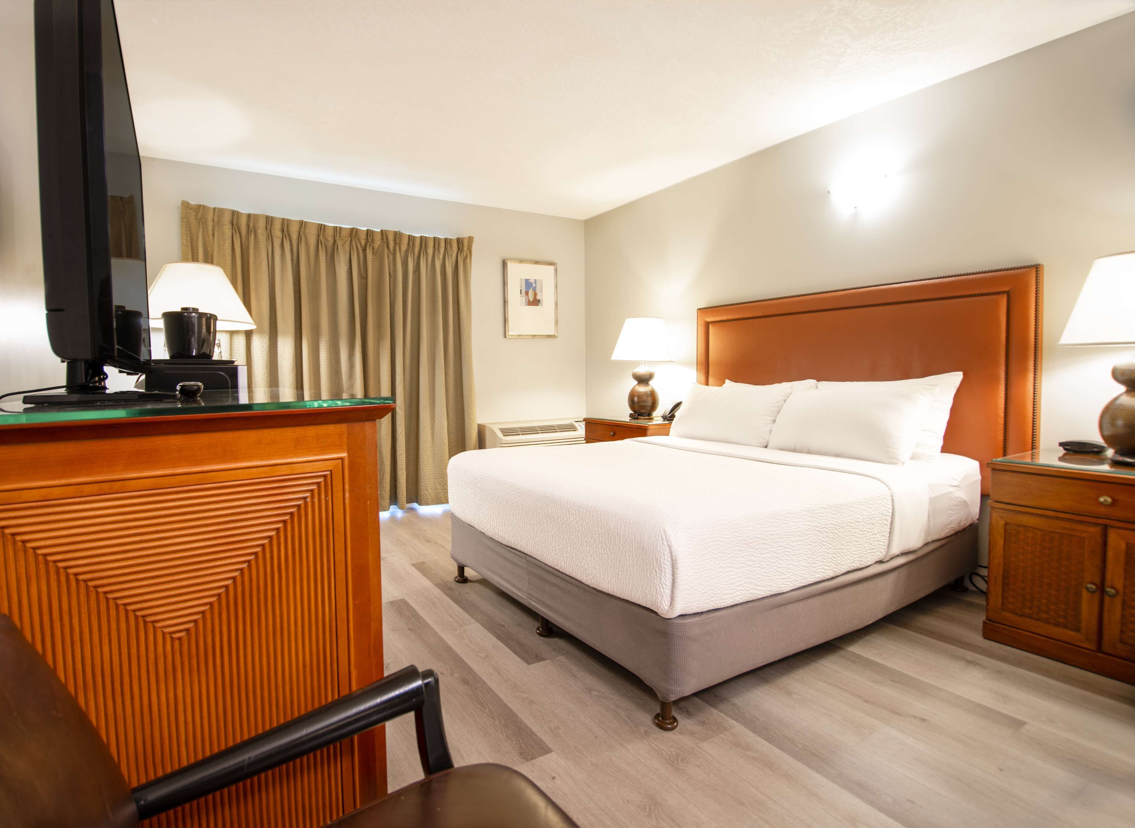 Premium bedding, desk, laptop workspace, blackout drapes